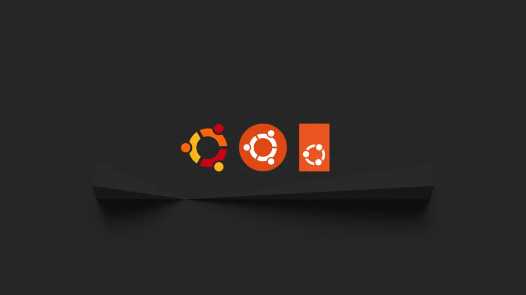 Wallpaper mostrando a evolução do logotipo do Ubuntu ao longo dos anos, em um fundo preto com três versões do logotipo em diferentes cores.