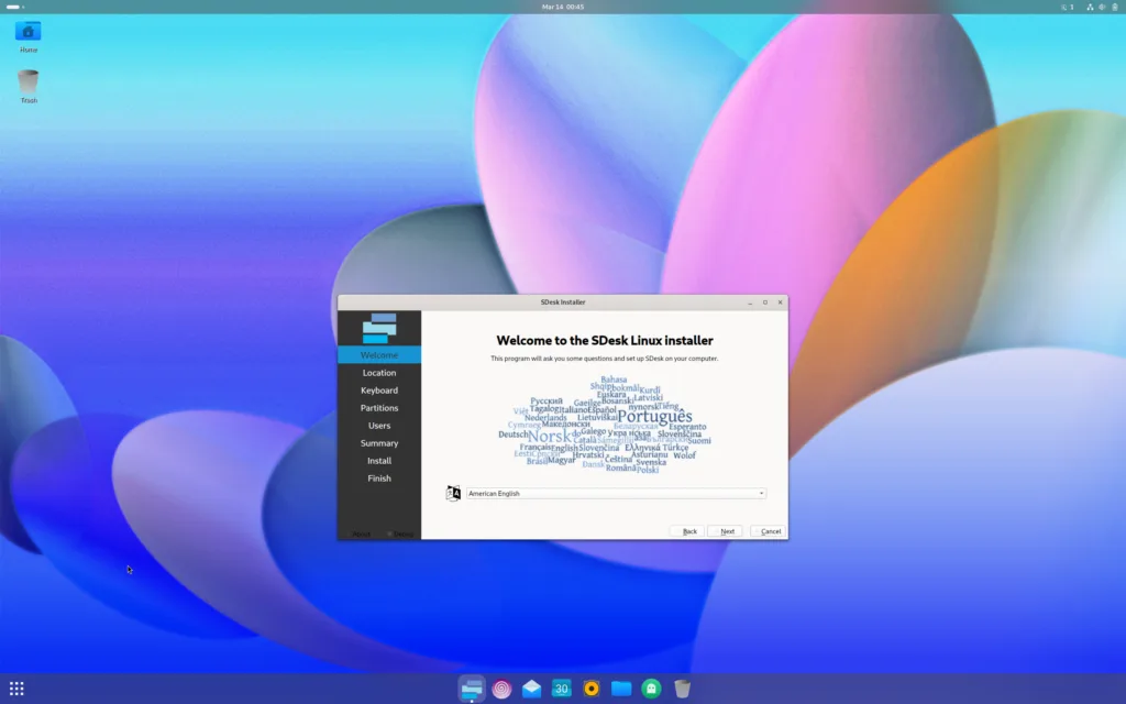 Instalador do SDesk Linux exibindo tela de boas-vindas com opções de idioma no ambiente GNOME, com fundo colorido abstrato e barra de tarefas inferior com ícones.