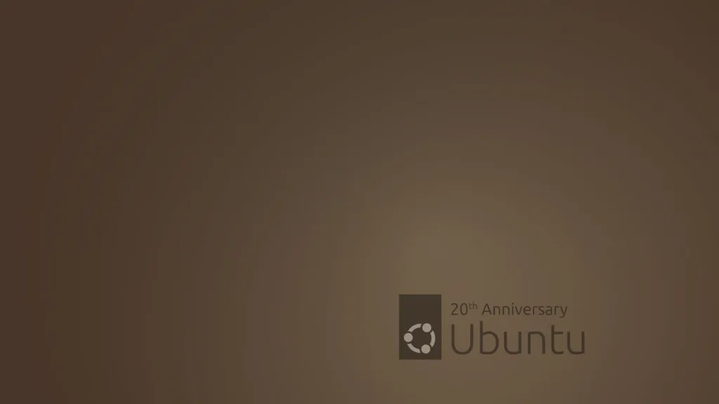 Wallpaper de 20º aniversário do Ubuntu, com fundo marrom e o logotipo do Ubuntu acompanhado do texto '20th Anniversary'.