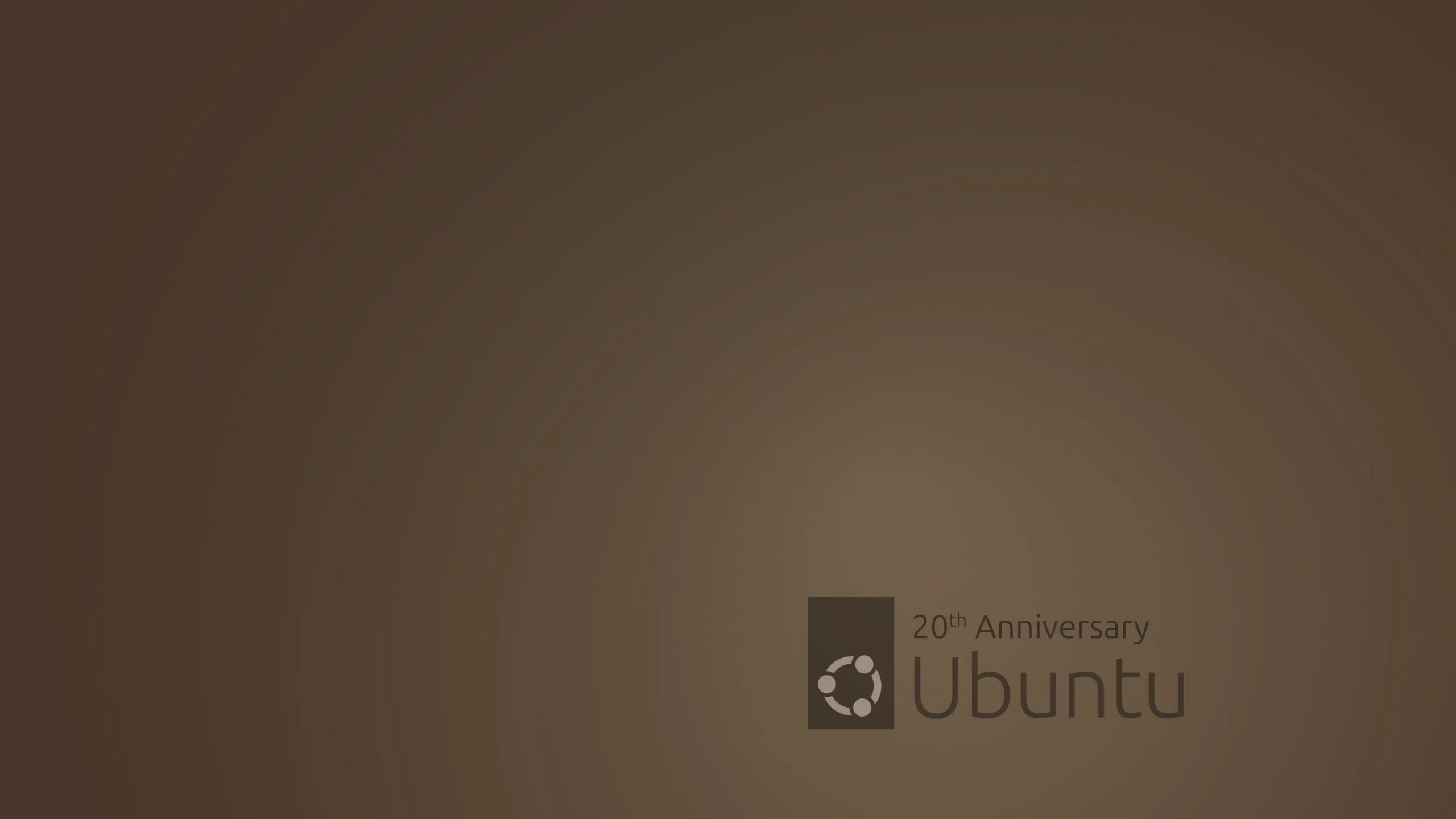 Wallpaper de 20º aniversário do Ubuntu, com fundo marrom e o logotipo do Ubuntu acompanhado do texto '20th Anniversary'.