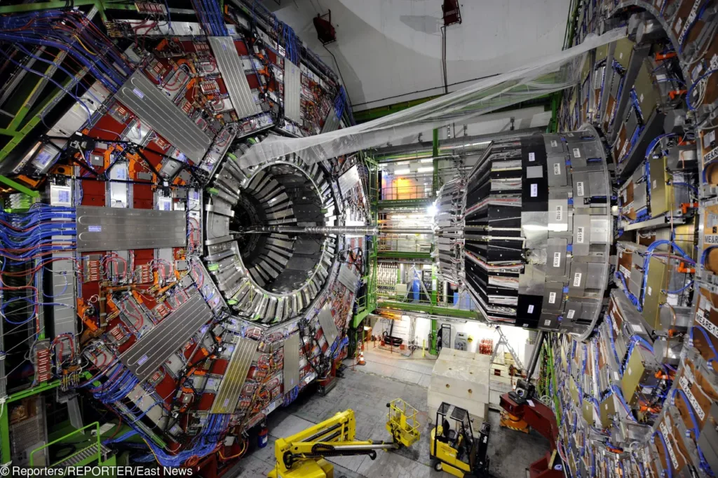 Vista detalhada do detector de partículas no Grande Colisor de Hádrons (LHC) no CERN, mostrando componentes e cabos intricados utilizados nas pesquisas científicas.