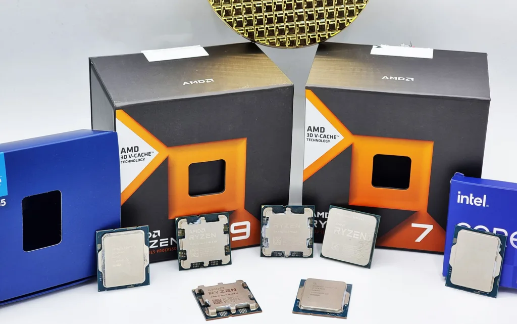 Imagem de processadores "CPUs" AMD e Intel com caixas de embalagem das linhas Ryzen 7, Ryzen 9 com tecnologia AMD 3D V-Cache e Intel Core ao fundo.