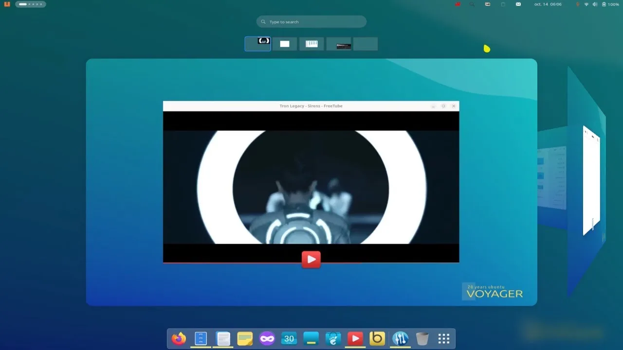 Voyager 24.10 lançado, distribuição Linux combina GNOME e Xfce em um sistema poderoso e leve 2 Interface do Voyager 24.10 mostrando a pré-visualização de múltiplas janelas abertas e um vídeo sendo reproduzido no FreeTube com o design da área de trabalho em estilo cubo