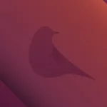 Imagem destaque do lançamento do Ubuntu 24.10 Oracular Oriole com fundo gradiente vermelho e laranja, apresentando a silhueta de um pássaro estilizado.