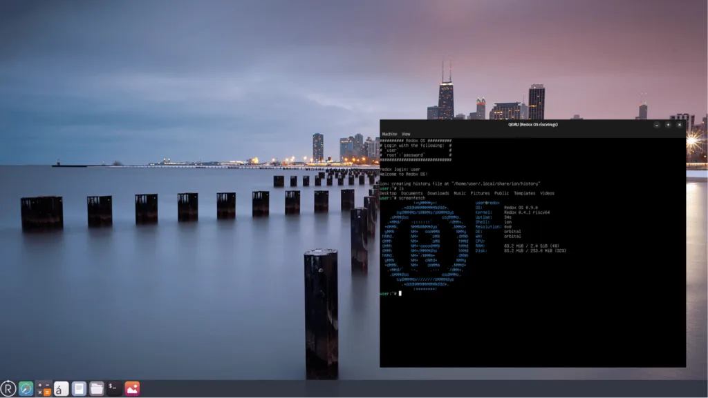 Captura de tela do desktop do Redox OS exibindo um terminal aberto. O terminal mostra o login do sistema com o usuário user e uma interface gráfica minimalista com uma barra de aplicativos na parte inferior da tela. A imagem de fundo apresenta uma paisagem urbana à noite.