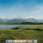 Tela inicial do elementary OS 8 com papel de parede de paisagem e dock exibindo ícones de aplicativos.