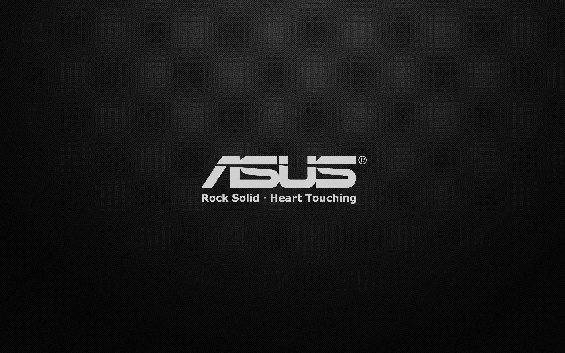 Logo da ASUS com o slogan 'Rock Solid, Heart Touching' sobre um fundo preto texturizado.