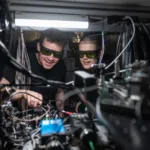 Dougal Main and Beth Nichol working on the distributed quantum computer. Credit John Cairns. RESIZED 0