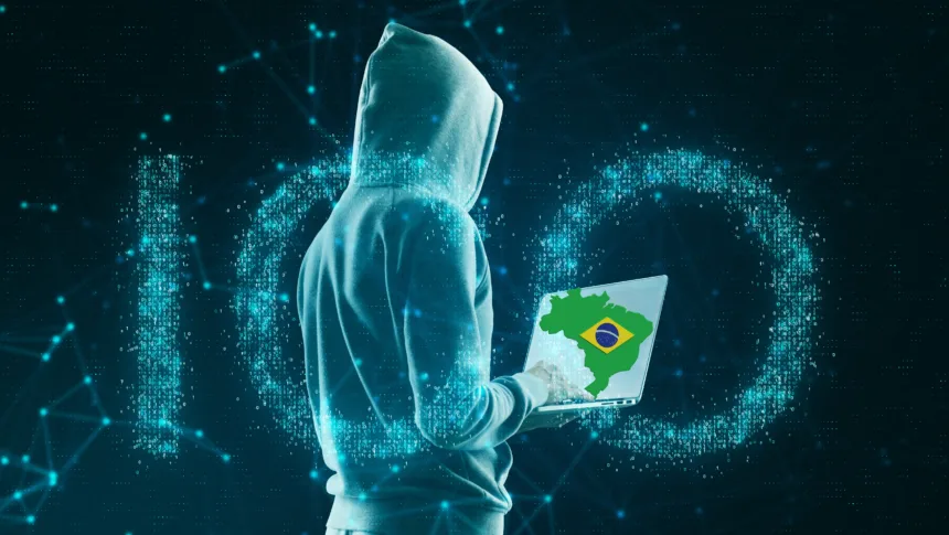 Hacker segurando notebook com mapa do Brasil, representando a ameaça do malware Shadow Vector.