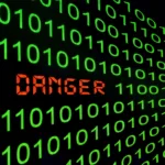 Sequência de zeros e uns em verde com a palavra ‘DANGER’ em vermelho no centro, ilustrando o botão de autodestruição Linux e o risco de comandos maliciosos.