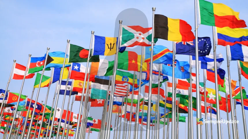 Diversas bandeiras de países com a silhueta do mascote Linux ao fundo, representando as restrições Linux internacional e batalhas legais Linux ao redor do mundo.