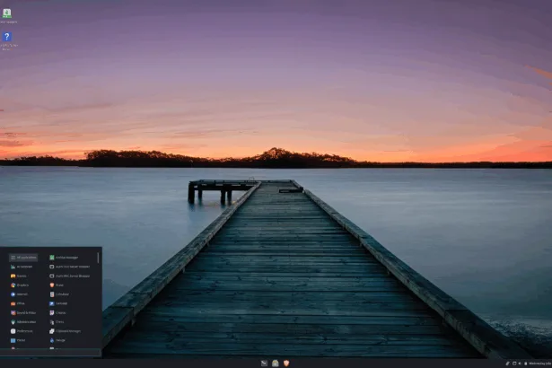 Área de trabalho padrão do Liya Linux 2.4 “Shravya” com papel de parede de pôr do sol, painel inferior e menu de aplicativos aberto