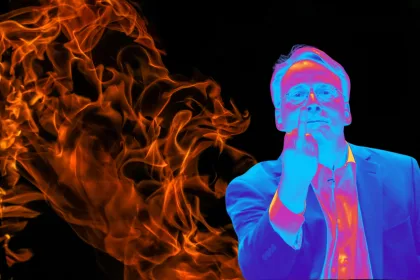 Homem de óculos em efeito térmico, de terno, faz gesto do dedo do meio diante de chamas em fundo preto